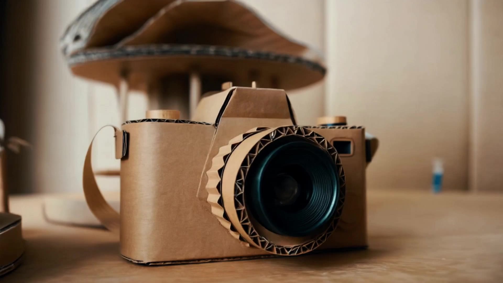 handcrafted cardboard camera sit - animated camera AI video
