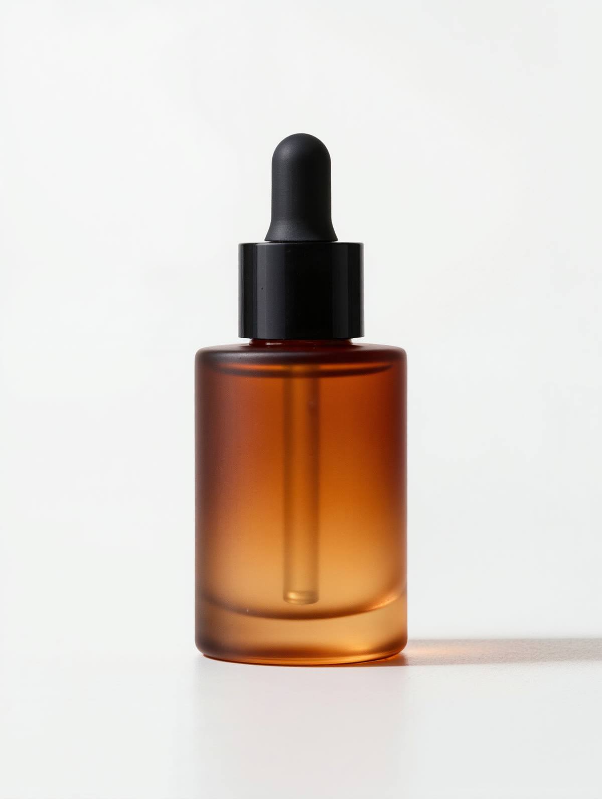 A frosted amber serum bottle on a plain white studio background — a bare e-commerce pack shot.